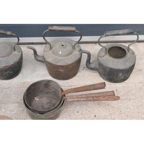 236 - A large collection of 19th and 20th century copper teapots, brass saucepans, scales and a large wick... 