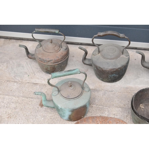 236 - A large collection of 19th and 20th century copper teapots, brass saucepans, scales and a large wick... 