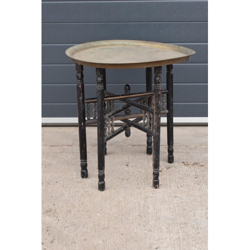 242 - A 20th century folding brass and wooden Indian or Indian style table. 60cm tall. In functional condi... 