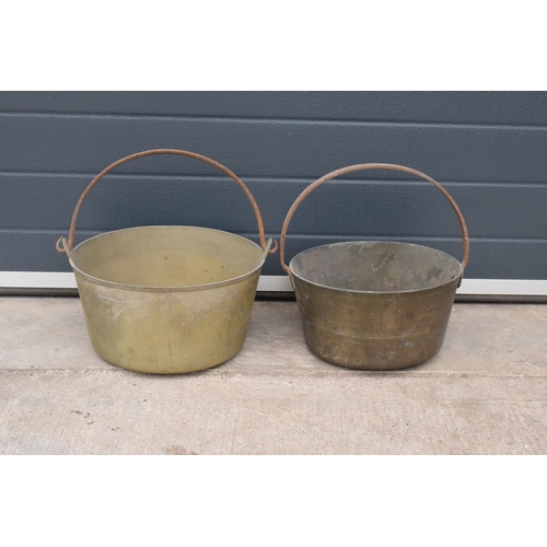 243 - A pair of antique brass jam pans in good condition, largest 36cm diameter.