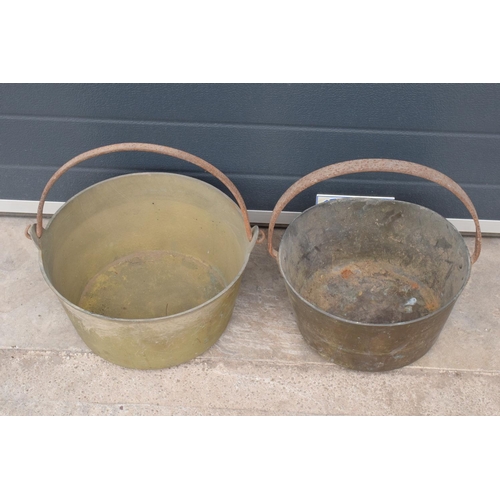 243 - A pair of antique brass jam pans in good condition, largest 36cm diameter.