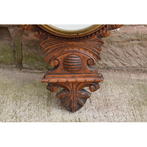 248 - A late Victorian/ Edwardian arts and crafts style carved aneroid barometer. 109cm tall. There are so... 