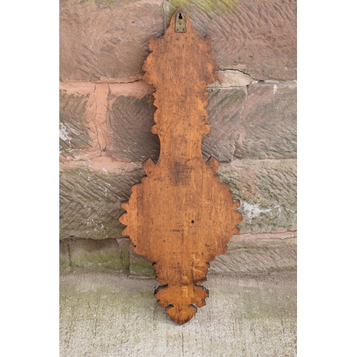 248 - A late Victorian/ Edwardian arts and crafts style carved aneroid barometer. 109cm tall. There are so... 