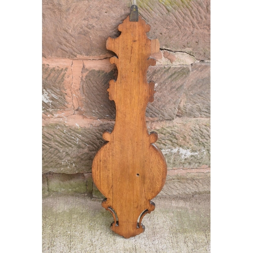 249 - A late Victorian/ Edwardian arts and crafts style carved aneroid barometer. 105cm tall. There are so... 