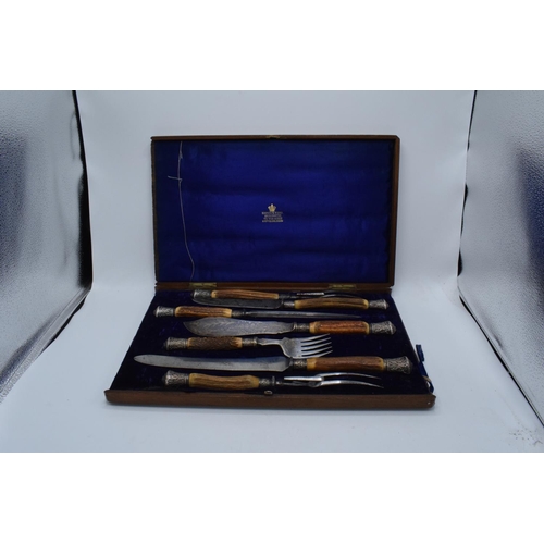 250 - A wooden cased Mappin and Webb horn and silver handled 7-piece carving set with silver banding and t... 