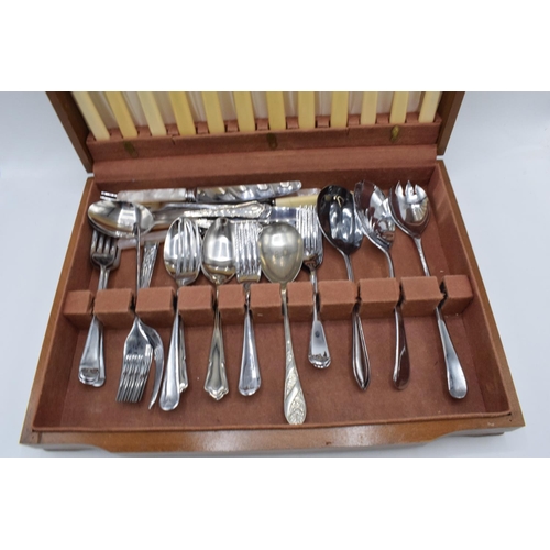 257 - An assorted cutlery canteen with chrome-plated and stainless steel cutlery in a wooden case.