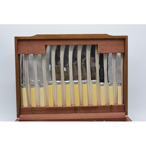 257 - An assorted cutlery canteen with chrome-plated and stainless steel cutlery in a wooden case.