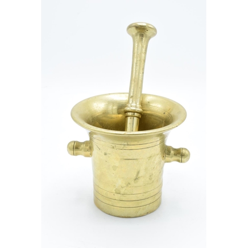 260 - A 20th century solid brass mortar and pestle (2). Very heavy. In good condition. Length of pestle is... 