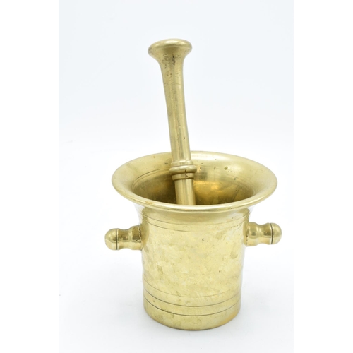 260 - A 20th century solid brass mortar and pestle (2). Very heavy. In good condition. Length of pestle is... 