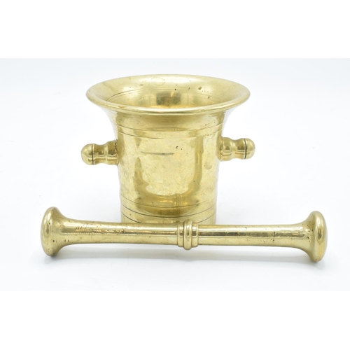 260 - A 20th century solid brass mortar and pestle (2). Very heavy. In good condition. Length of pestle is... 