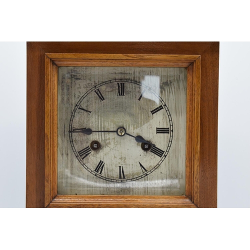 265 - A 20th century wooden cased mantle clock 'J Unghans' with bevel-edged glass and an associated key. A... 