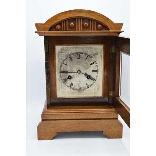 265 - A 20th century wooden cased mantle clock 'J Unghans' with bevel-edged glass and an associated key. A... 