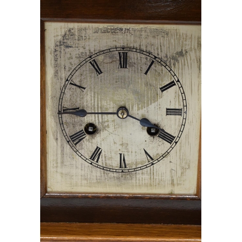 265 - A 20th century wooden cased mantle clock 'J Unghans' with bevel-edged glass and an associated key. A... 