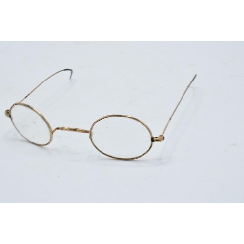 269A - A cased pair of 1/10 10ct gold oval spectacles in original leather carry case by N. J. Rees of 36 Ma... 