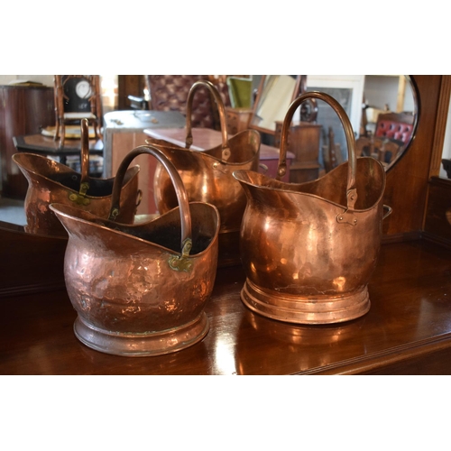 270 - A pair of copper coal buckets to include a hammered Victorian bucket together with a later example (... 