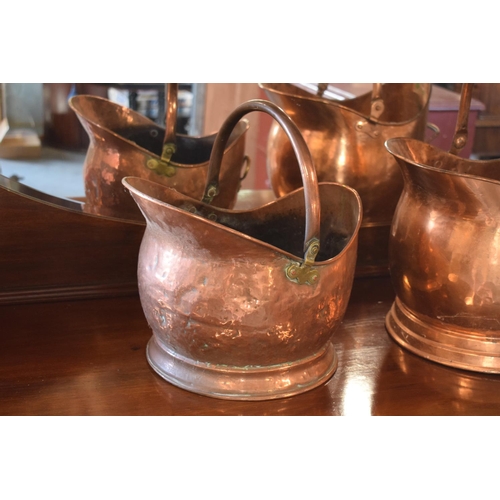 270 - A pair of copper coal buckets to include a hammered Victorian bucket together with a later example (... 