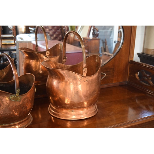 270 - A pair of copper coal buckets to include a hammered Victorian bucket together with a later example (... 