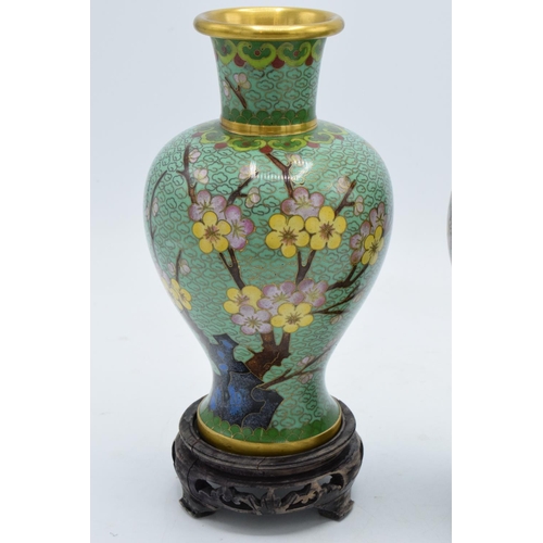 277 - A pair of 20th century cloisonné vases decorated with a green foliage design on wooden bases (2). 22... 