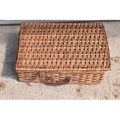 285 - A vintage mid to late 20th century picnic set in a wicker travelling case (part set).