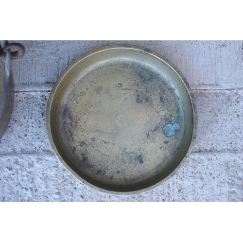 287 - A late 19th/ early 20th century solid brass jam pan together with a brass dish (2). 33cm diameter.