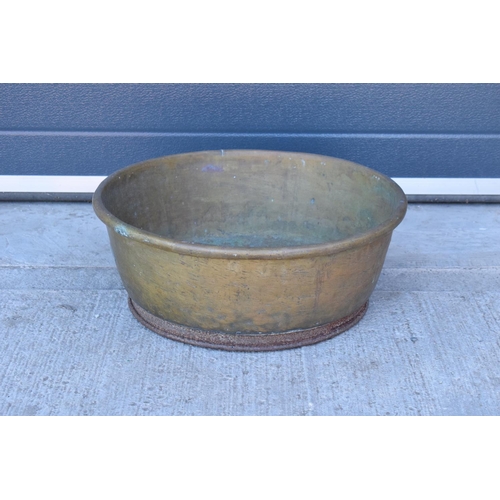 288 - A large oversized antique brass bowl/ basket on a steel base which was used as a log basket/ store. ... 