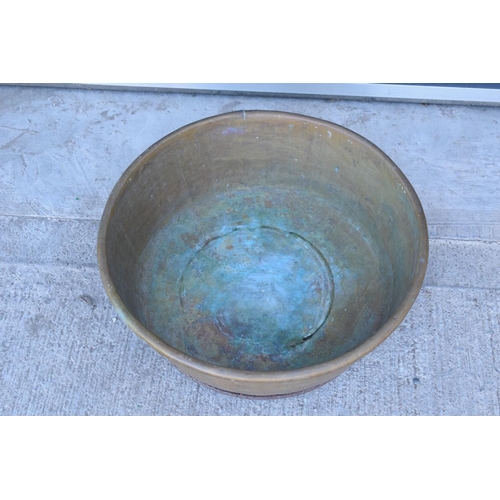 288 - A large oversized antique brass bowl/ basket on a steel base which was used as a log basket/ store. ... 