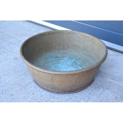 288 - A large oversized antique brass bowl/ basket on a steel base which was used as a log basket/ store. ... 