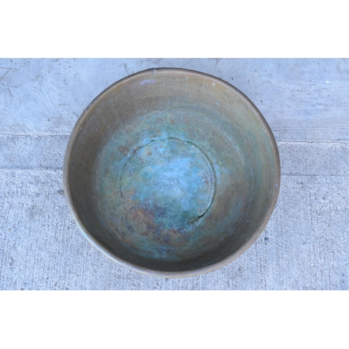 288 - A large oversized antique brass bowl/ basket on a steel base which was used as a log basket/ store. ... 