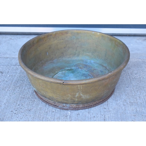 288 - A large oversized antique brass bowl/ basket on a steel base which was used as a log basket/ store. ... 