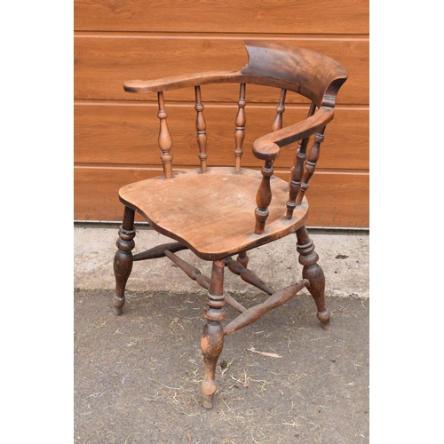 292 - A late 19th century elm or similar wood captain's chair. 79cm tall. In good functional condition tho... 