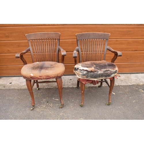 293 - A pair of Edwardian office or captains style chairs with upholstered seats on casters. The upholster... 