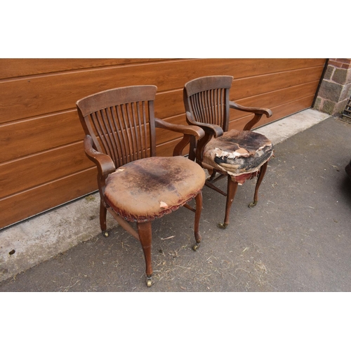 293 - A pair of Edwardian office or captains style chairs with upholstered seats on casters. The upholster... 