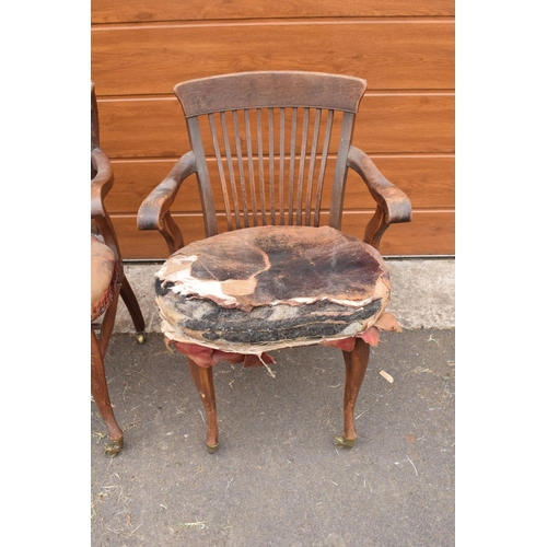 293 - A pair of Edwardian office or captains style chairs with upholstered seats on casters. The upholster... 