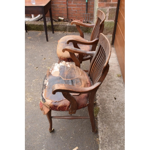 293 - A pair of Edwardian office or captains style chairs with upholstered seats on casters. The upholster... 