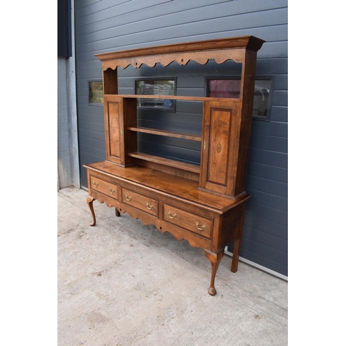 299 - A good quality reproduction Georgian style oak dresser set on cabriole legs with marquetry and inlay... 