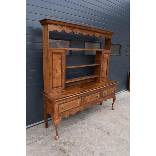 299 - A good quality reproduction Georgian style oak dresser set on cabriole legs with marquetry and inlay... 