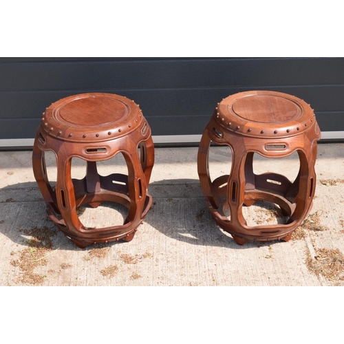 310 - A pair of 20th century Chinese style hardwood barrel/ drum stools. 46cm tall. 41cm at the widest poi... 