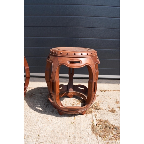 310 - A pair of 20th century Chinese style hardwood barrel/ drum stools. 46cm tall. 41cm at the widest poi... 