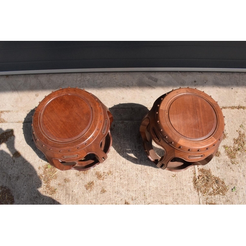 310 - A pair of 20th century Chinese style hardwood barrel/ drum stools. 46cm tall. 41cm at the widest poi... 