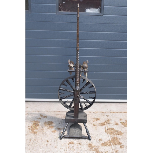 312 - A late 19th century wooden spinning wheel 153cm tall. In good condition with signs of wear and use a... 