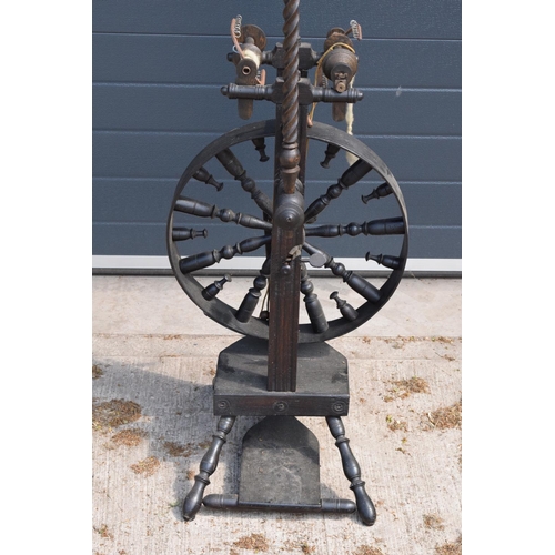 312 - A late 19th century wooden spinning wheel 153cm tall. In good condition with signs of wear and use a... 