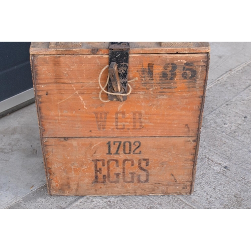 313 - A vintage 20th century wooden egg crate with either 'WCB' or 'WGB' with 'EGGS' on each side and a bo... 