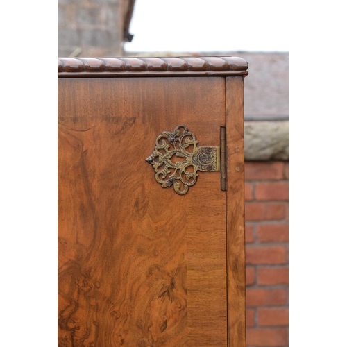 319 - An early 20th Century Queen Anne style walnut drinks / cocktail cabinet with the doors opening to re... 