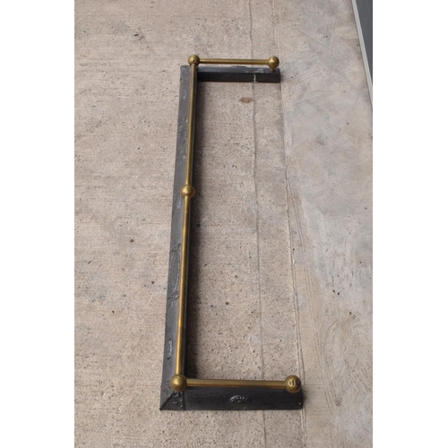 326 - An early 20th century cast metal fireside fender with brass rail. 121 x 37cm.