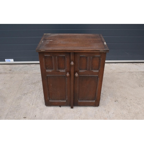 327 - A wooden 20th century Priory style sideboard with a fold-out table top. Largest dimensions 138 x 70 ... 