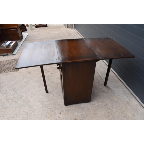 327 - A wooden 20th century Priory style sideboard with a fold-out table top. Largest dimensions 138 x 70 ... 