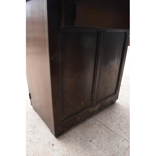 327 - A wooden 20th century Priory style sideboard with a fold-out table top. Largest dimensions 138 x 70 ... 