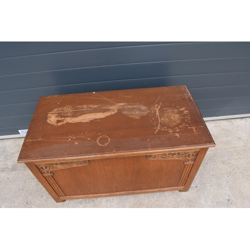 328 - A 1930s wooden blanket box with an ornate carved section. 96 x 50 x 57cm. In good functional conditi... 