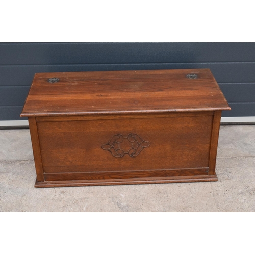 329 - A 1930s wooden blanket box with ornate central design. 91 x 44 x 43cm tall.