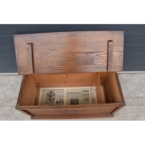 329 - A 1930s wooden blanket box with ornate central design. 91 x 44 x 43cm tall.